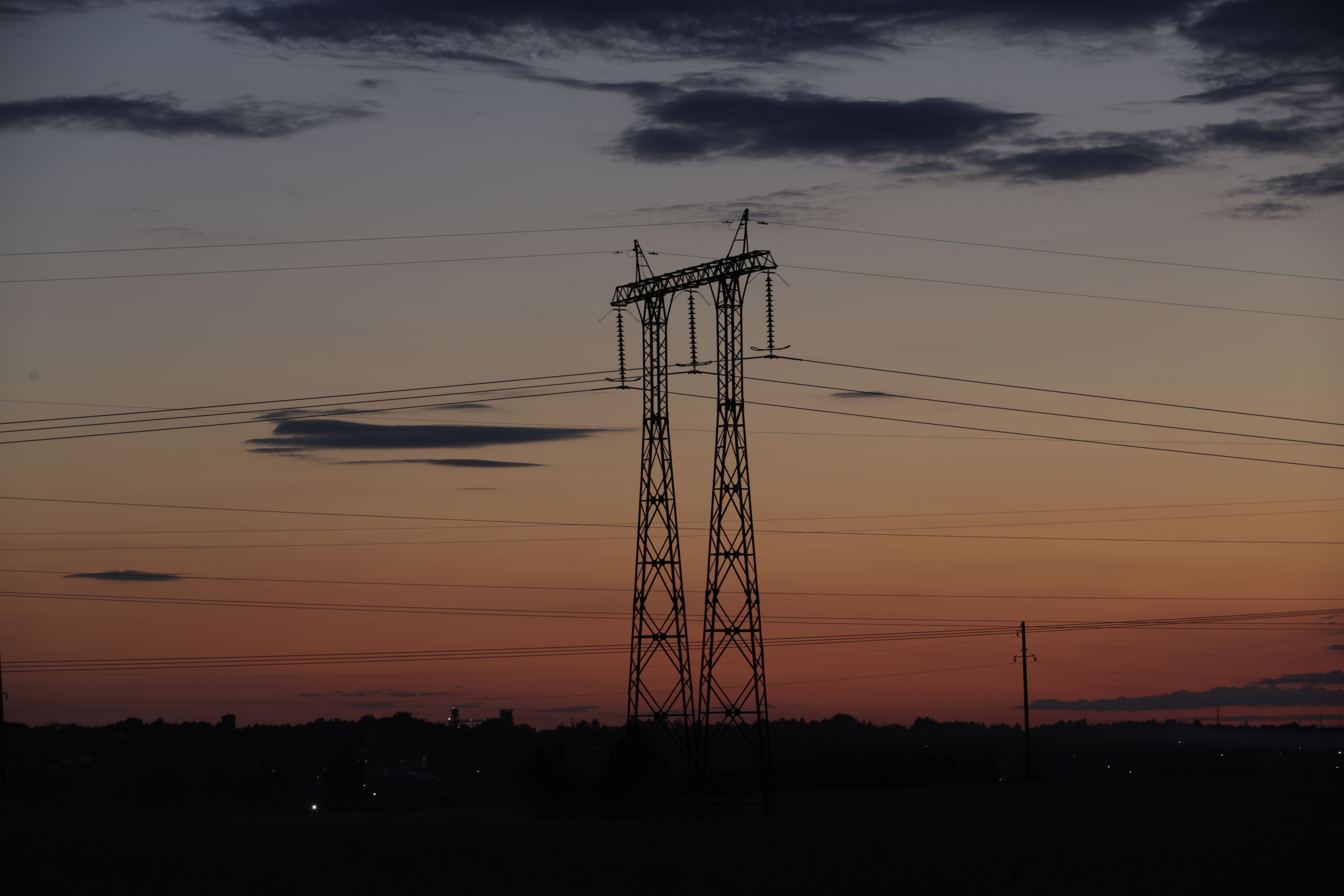 High-voltage power transmission infrastructure at sunset